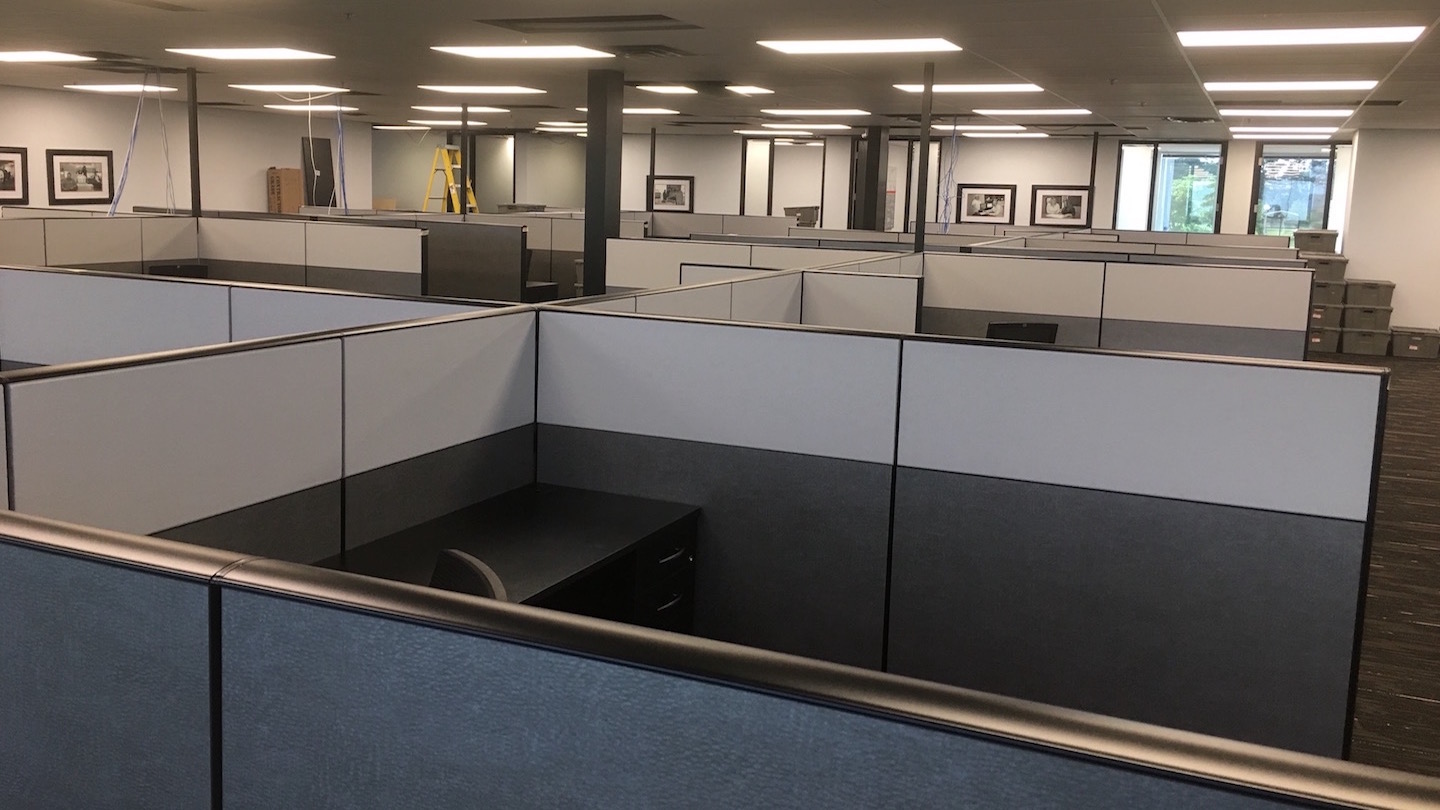 Cubicle walls and desks installed in the empty office.
