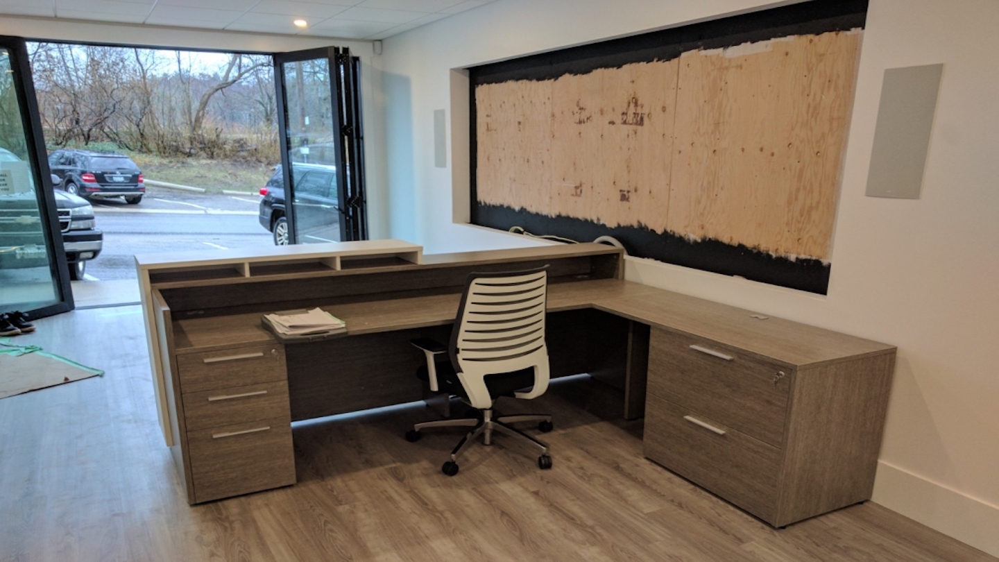 a custom office furniture set moved and installed in a personal office.