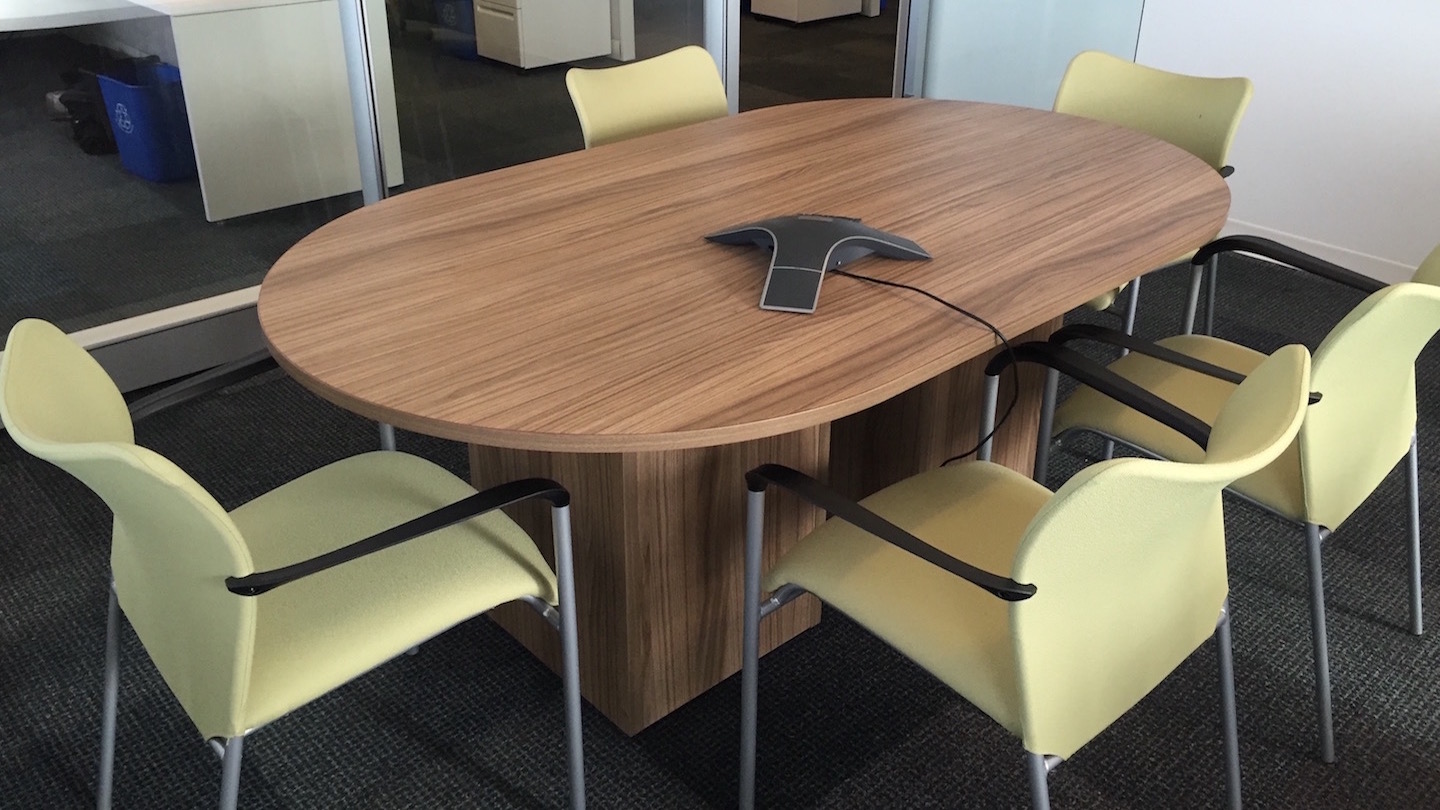 A medium sized table set with office chairs delivered and installed in an office.