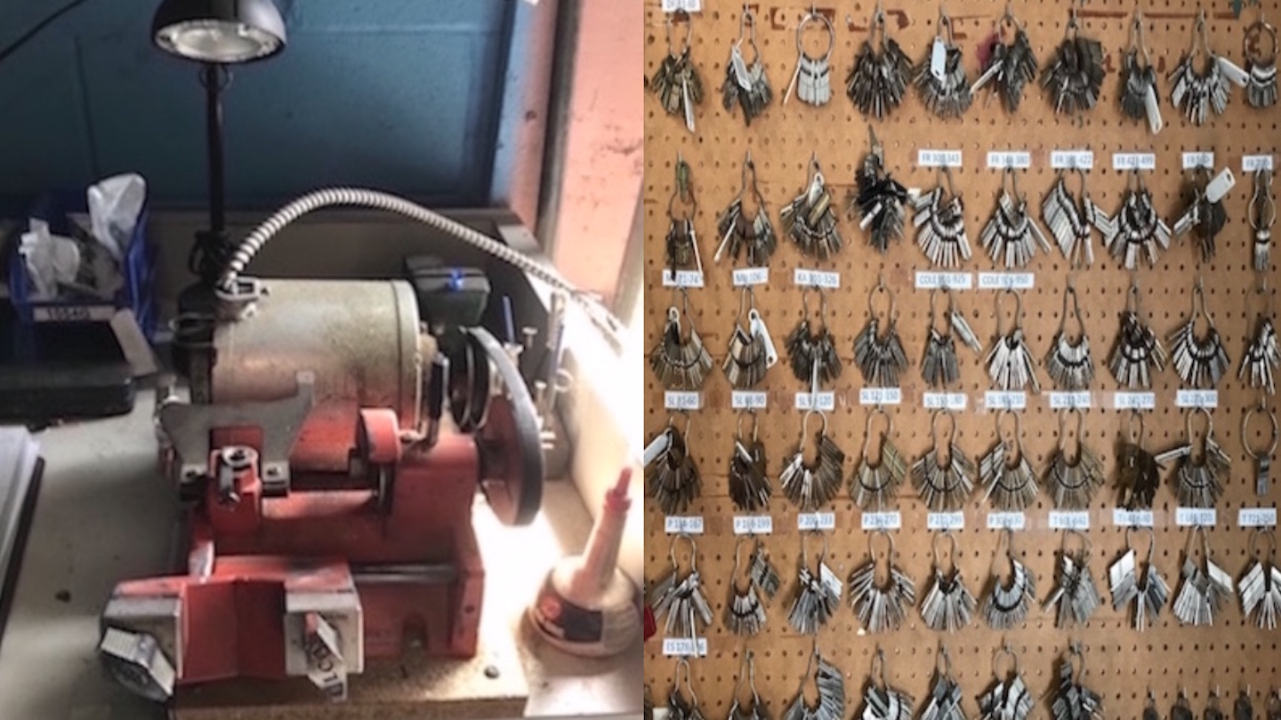 Key cutting machine beside a hanging board full of many custom-cut keys.